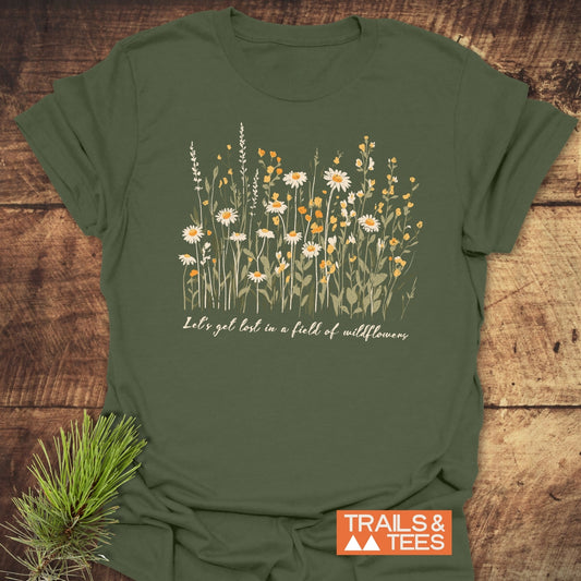 Close-up of 'Lets Get Lost In A Field Of Wildflowers' T-Shirt featuring white and orange floral pattern on soft, lightweight ring-spun cotton.