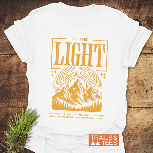 Be The Light, Matthew 5:14-16 T-Shirt featuring gold text, crafted from soft, lightweight cotton for everyday adventures. Durable print and pre-shrunk for a reliable fit.