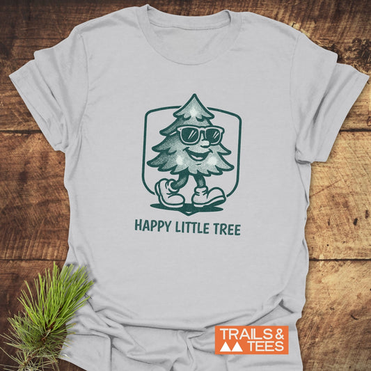 Happy Little Tree T-Shirt featuring a cartoon Christmas tree wearing sunglasses, crafted from lightweight cotton for adventure-ready comfort and durability.
