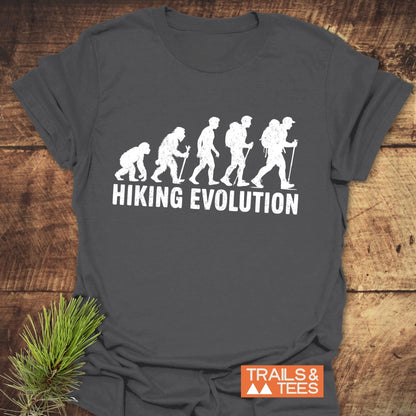 Hiking Evolution T-Shirt featuring white text on a grey fabric, ideal for active wear, showcasing a silhouette of a person with a backpack.