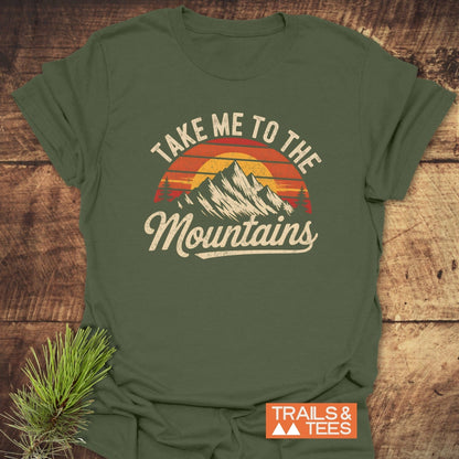 Take Me To The Mountains T-Shirt featuring bold white text and a graphic design on a close-fitting, activewear style shirt.