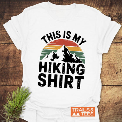 This Is My Hiking Shirt T-Shirt featuring mountain graphics and text, captured in a close-up view emphasizing its active, adventurous design.