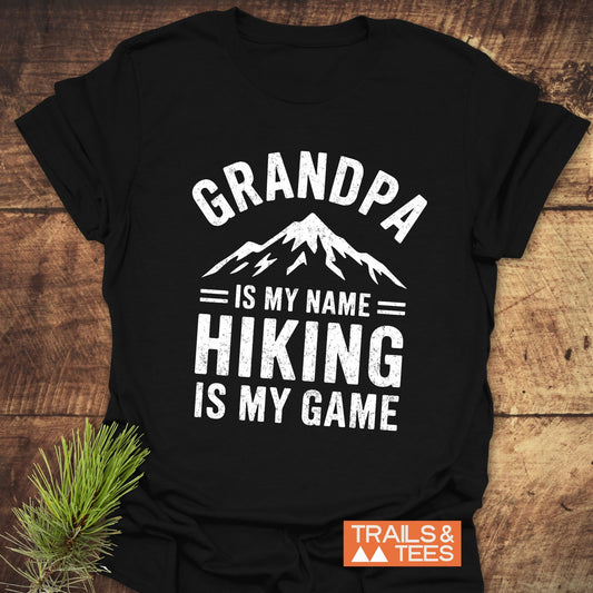 Grandpa Is My Name Hiking Is My Game T-Shirt with bold white text on a black background, exemplifying active, casual wear.
