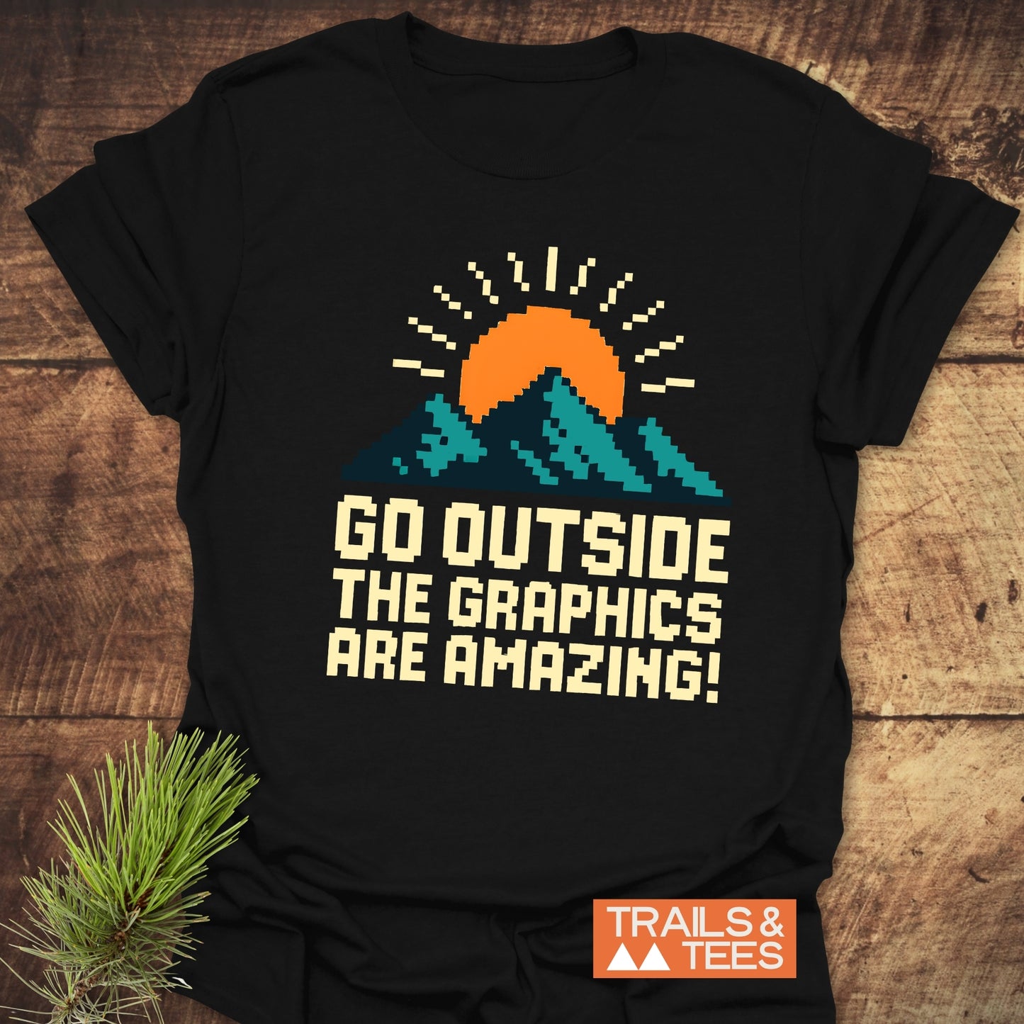 Go Outside Pixelart Mountain T-Shirt features a sun and mountain graphic, crafted from lightweight ring-spun cotton for comfort and durability, ideal for outdoor enthusiasts.
