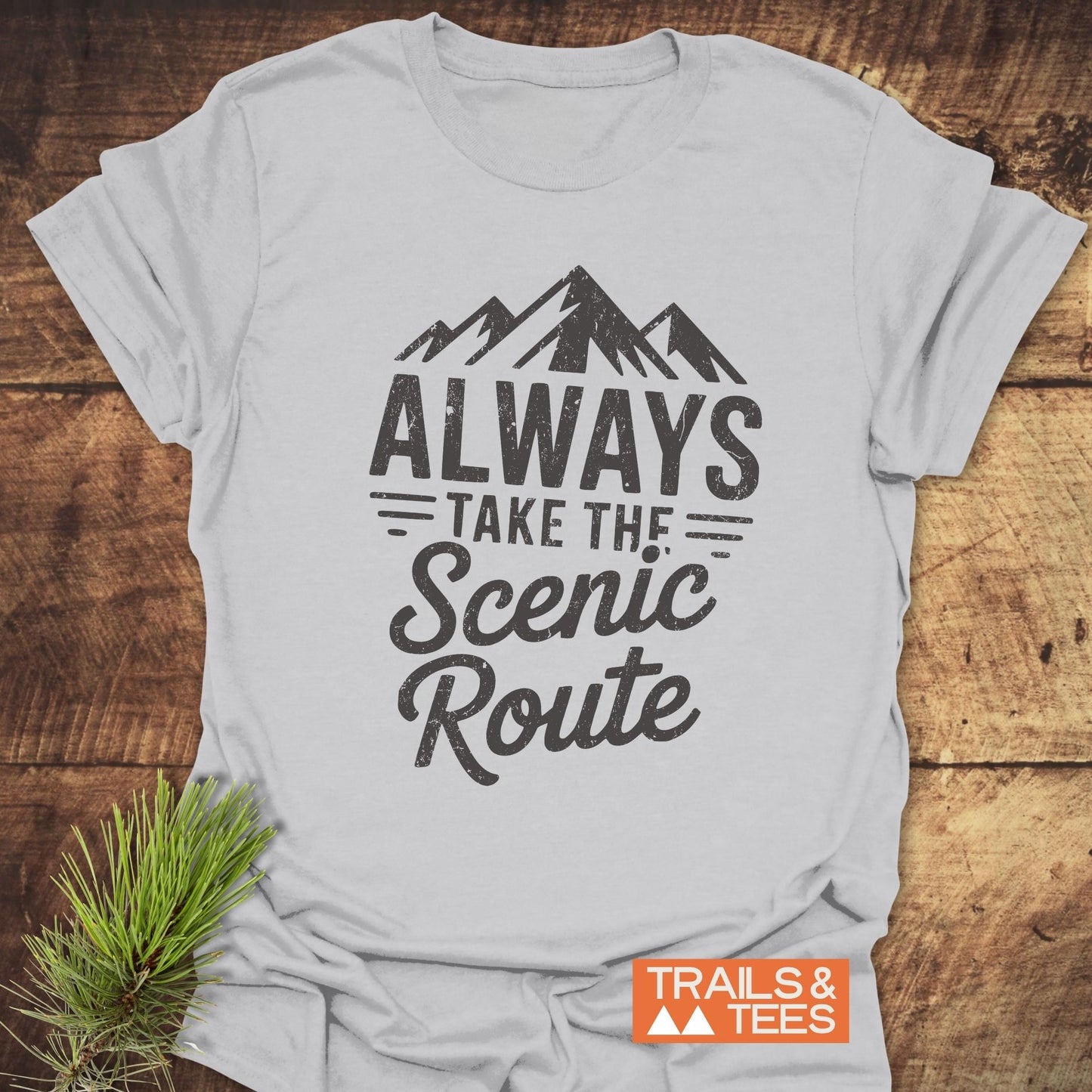 Close-up of the Always Take The Scenic Route T-Shirt, highlighting its active design and text detail on the shirt.