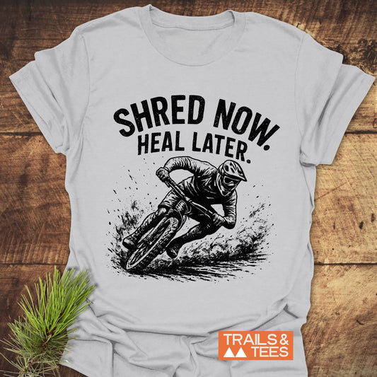 Shred Now Heal Later Mountainbike T-Shirt featuring a man riding a bike, crafted from soft, lightweight cotton for everyday outdoor adventures.