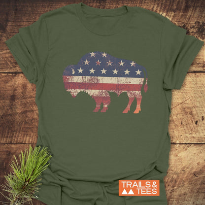Land Of The Free Bison T-Shirt featuring a close-up of a buffalo with stars and stripes. Soft cotton, durable print, designed for outdoor enthusiasts.