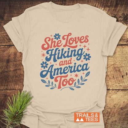 She Loves Hiking And America Too T-Shirt with text design, made from soft ring-spun cotton, offering comfort and durability for outdoor enthusiasts.
