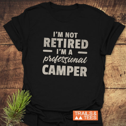 Not Retired T-Shirt: Black shirt with bold white text, crafted from soft ring-spun cotton, designed for comfort and durability during outdoor adventures.