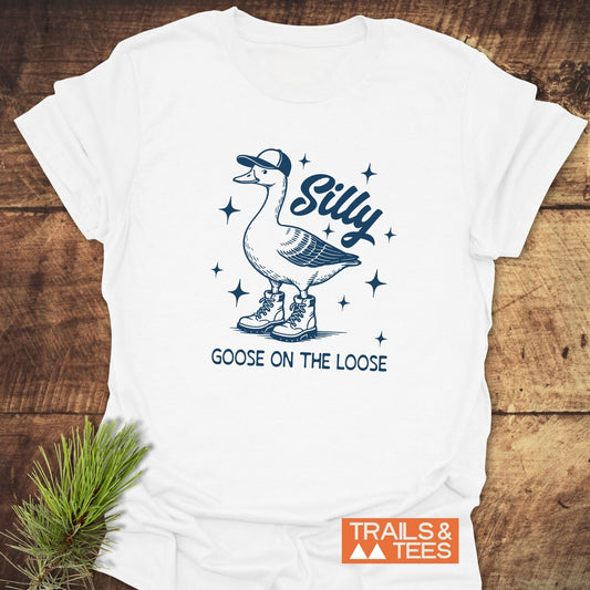 Silly Goose T-Shirt featuring a line drawing of a goose in boots and a cap, with Silly Goose on the Loose text, and TRAILS & TEES logo.
