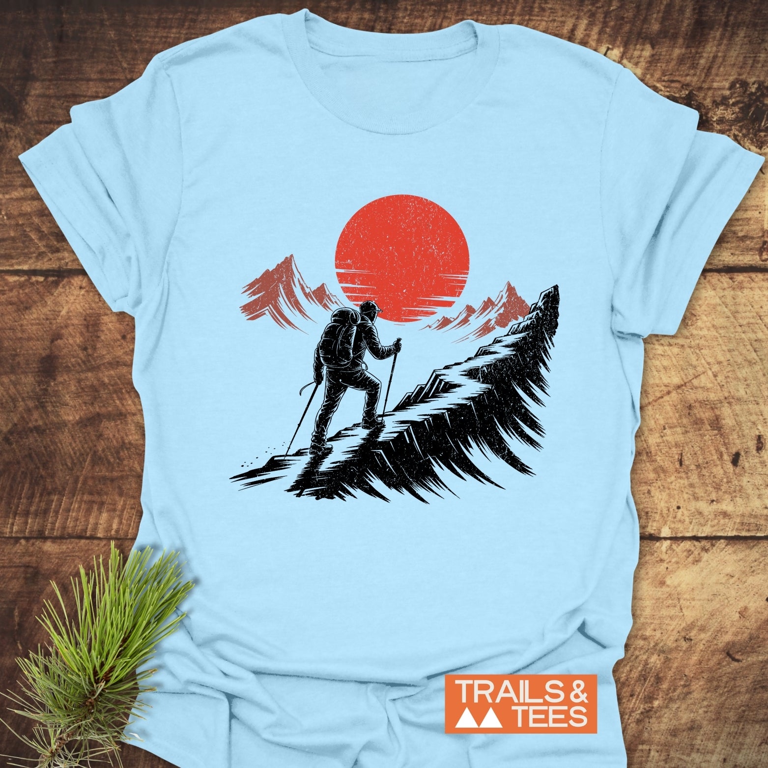 Hiker Sunset T-Shirt featuring a hiker graphic with trekking poles on a mountain ridge, crafted from soft ring-spun cotton, perfect for outdoor enthusiasts.