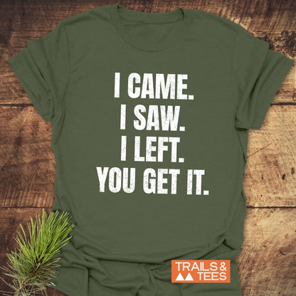 Olive-green I Came. I Saw. I Left. T-shirt by Trails & Tees on wooden surface, features durable, distressed white slogan print, ideal for outdoor enthusiasts.