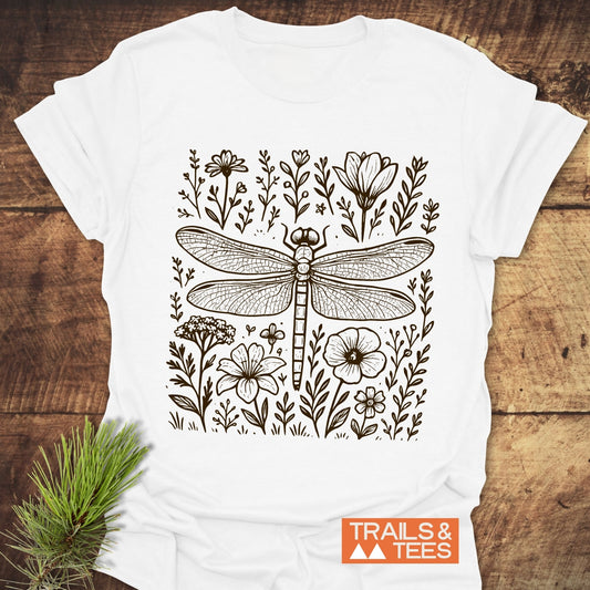 Dragonfly T-Shirt featuring a black line-drawing of a dragonfly with wildflowers, crafted from soft ring-spun cotton, showcasing outdoor adventure spirit.