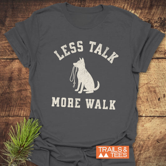 Less Talk, More Walk T-Shirt featuring a dog silhouette with leash. Made from soft cotton, pre-shrunk, durable print. Ideal for outdoor enthusiasts.