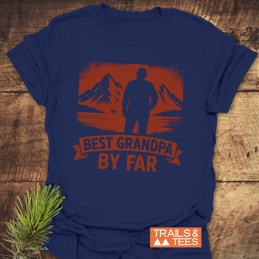 Navy blue Best Grandpa By Far T-shirt with outdoor scene, made of soft ring-spun cotton, featuring Trails & Tees logo, on wooden surface.
