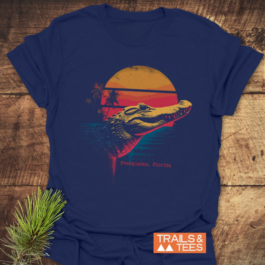 Everglades Alligator T-Shirt featuring a retro alligator graphic with sunset and palm trees. Made from soft, pre-shrunk cotton for comfort.