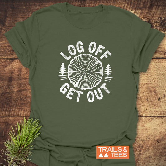 Log Off Get Out T-Shirt featuring a stylized tree-ring design with text, laid on wood. Soft, durable, pre-shrunk cotton perfect for outdoor enthusiasts.