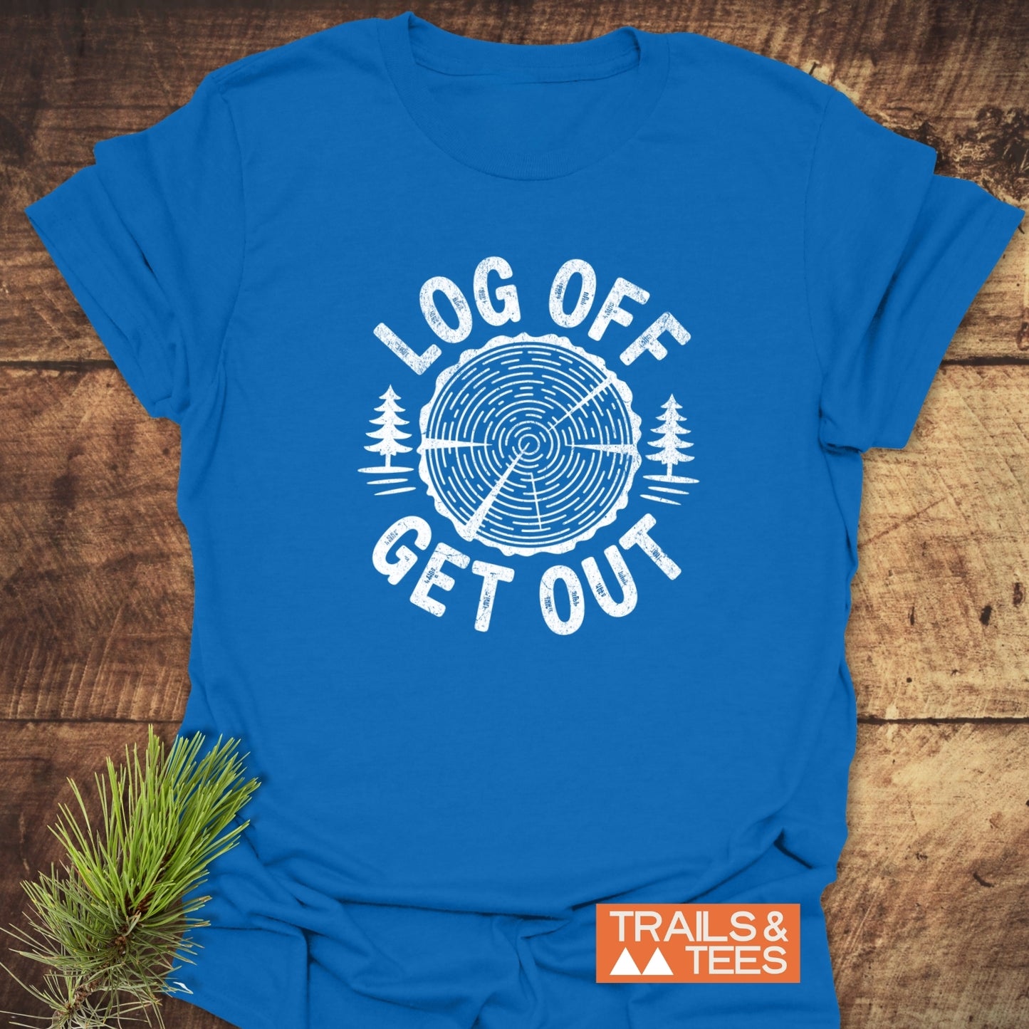 Log Off Get Out T-Shirt featuring a tree-ring graphic with pine trees, showcasing durable prints on soft, lightweight cotton for outdoor enthusiasts.