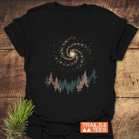 Woodland Nightsky T-Shirt with galaxy and pine tree graphic, showcasing outdoor spirit. Features soft, durable cotton for comfort and adventure.