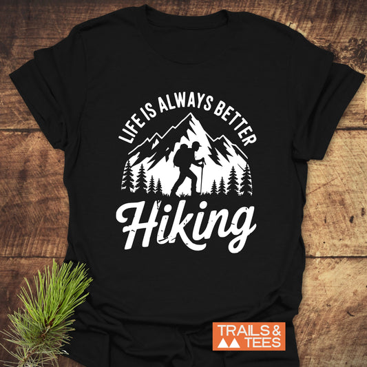 Life Is Always Better Hiking T-Shirt featuring a hiker graphic, crafted from soft cotton, with durable prints and a Trails & Tees logo.