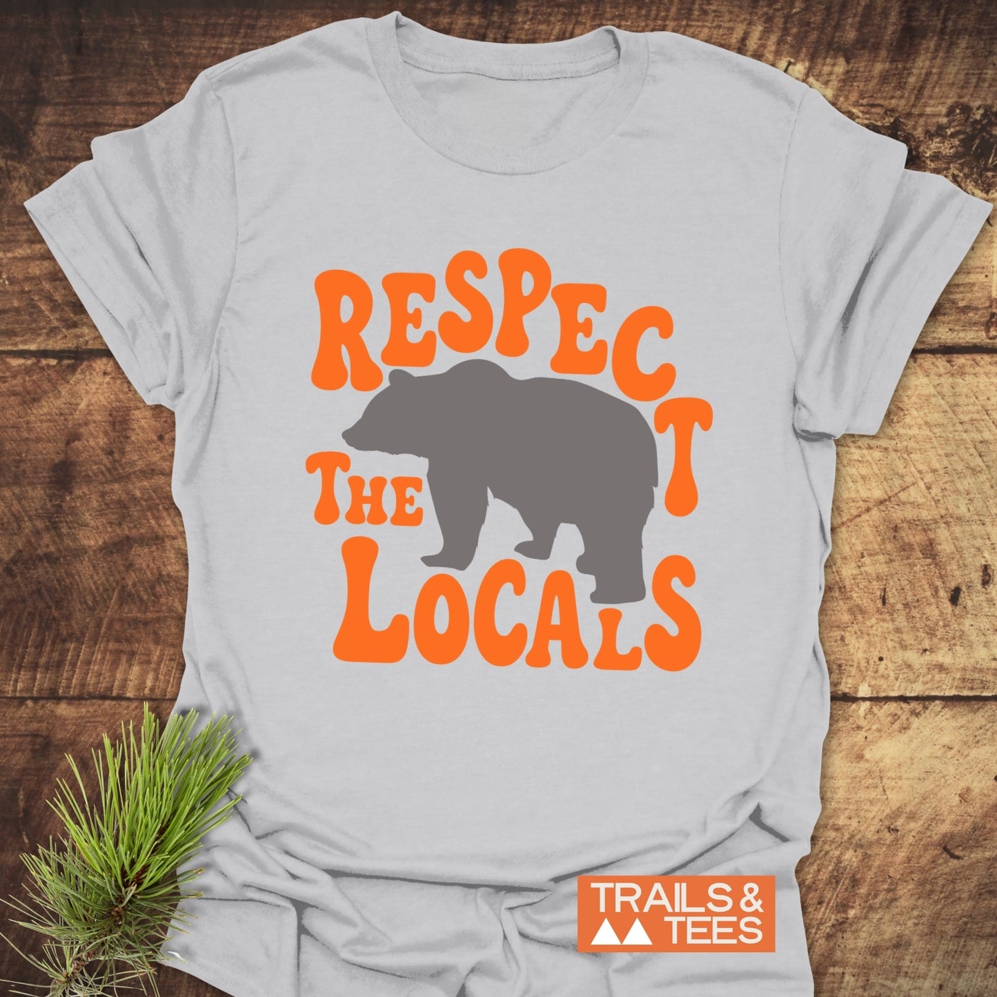 Respect The Locals Bear T-Shirt featuring a gray bear silhouette with bold orange text, crafted from soft ring-spun cotton for everyday outdoor adventures.