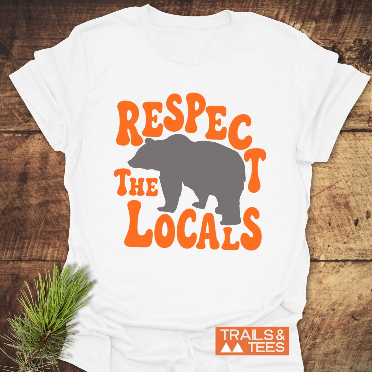 Respect The Locals Bear T-Shirt featuring bold orange lettering around a bear silhouette on soft cotton, designed for comfort and outdoor adventures.