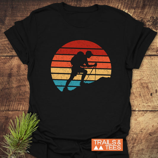 Uphill Hiker T-Shirt with retro graphic of a hiker on a slope. Crafted from soft cotton, perfect for outdoor enthusiasts.