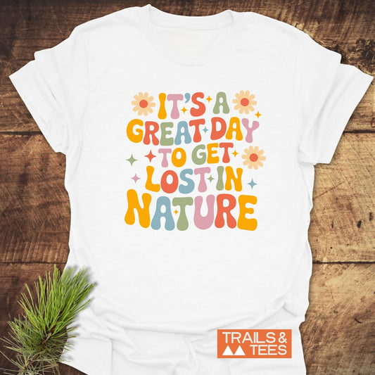White T-shirt with colorful retro slogan IT’S A GREAT DAY TO GET LOST IN NATURE, featuring TRAILS & TEES logo; crafted for outdoor adventures.