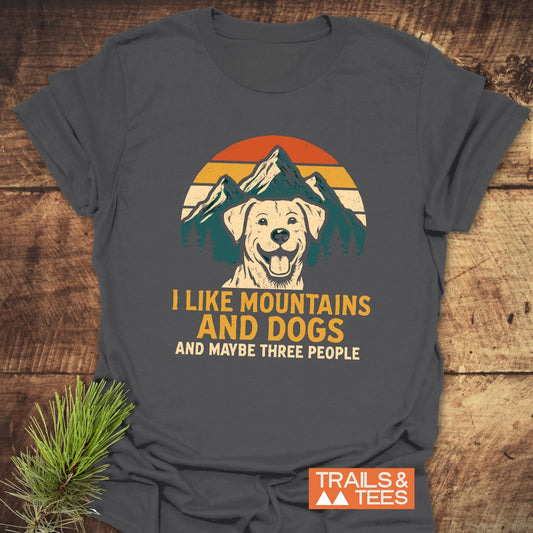 I Like Mountains & Dogs T-Shirt featuring a retro dog and mountain graphic on dark-gray cotton, highlighting outdoor adventure spirit.