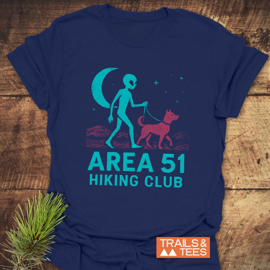 Area 51 Hiking Club T-Shirt: Navy tee featuring an alien graphic with a dog, desert scene, and logo, crafted from soft cotton for outdoor enthusiasts.