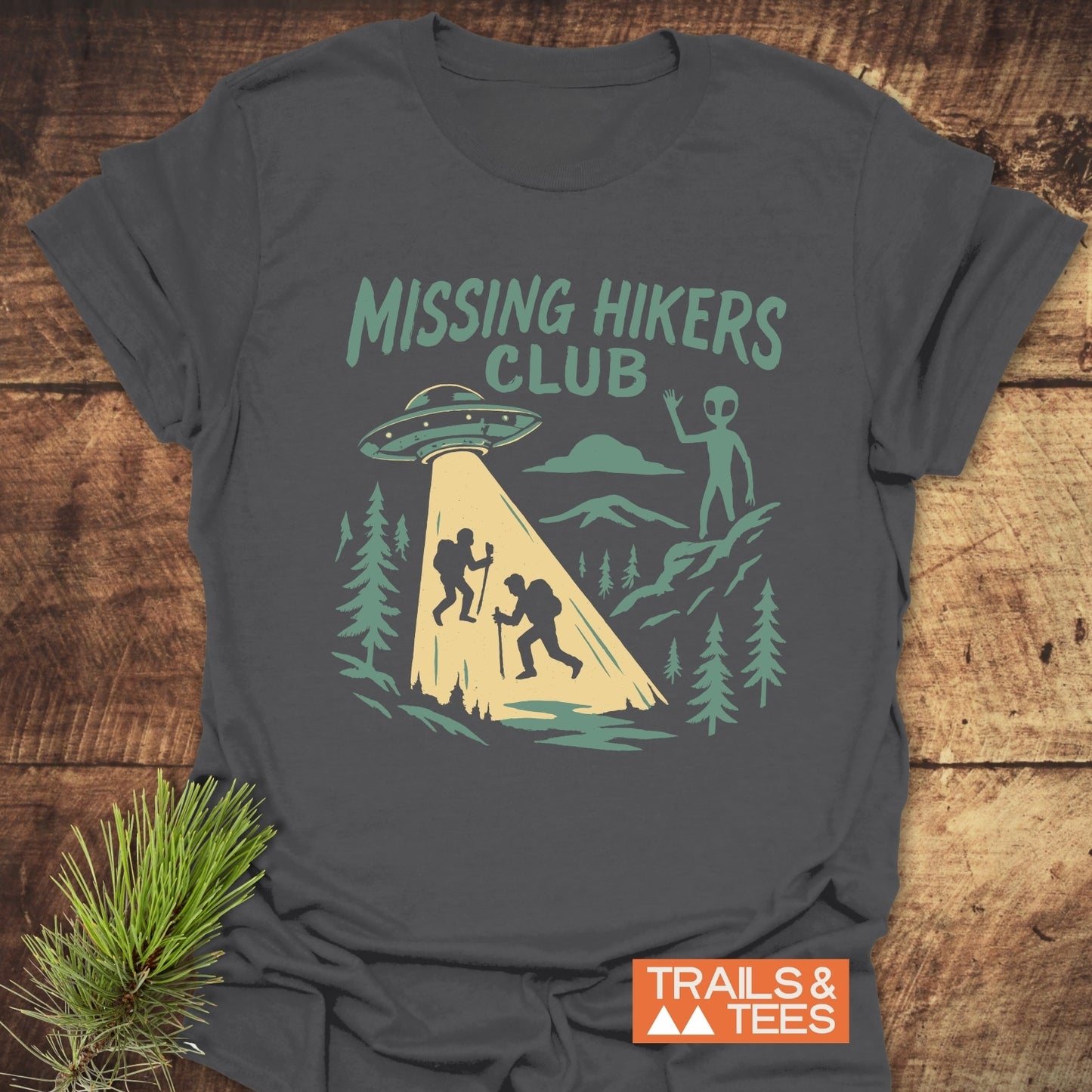 Missing Hikers Club T-Shirt with vintage graphic of hikers and UFO, crafted from soft ring-spun cotton, offering trail-tested comfort and durable print.
