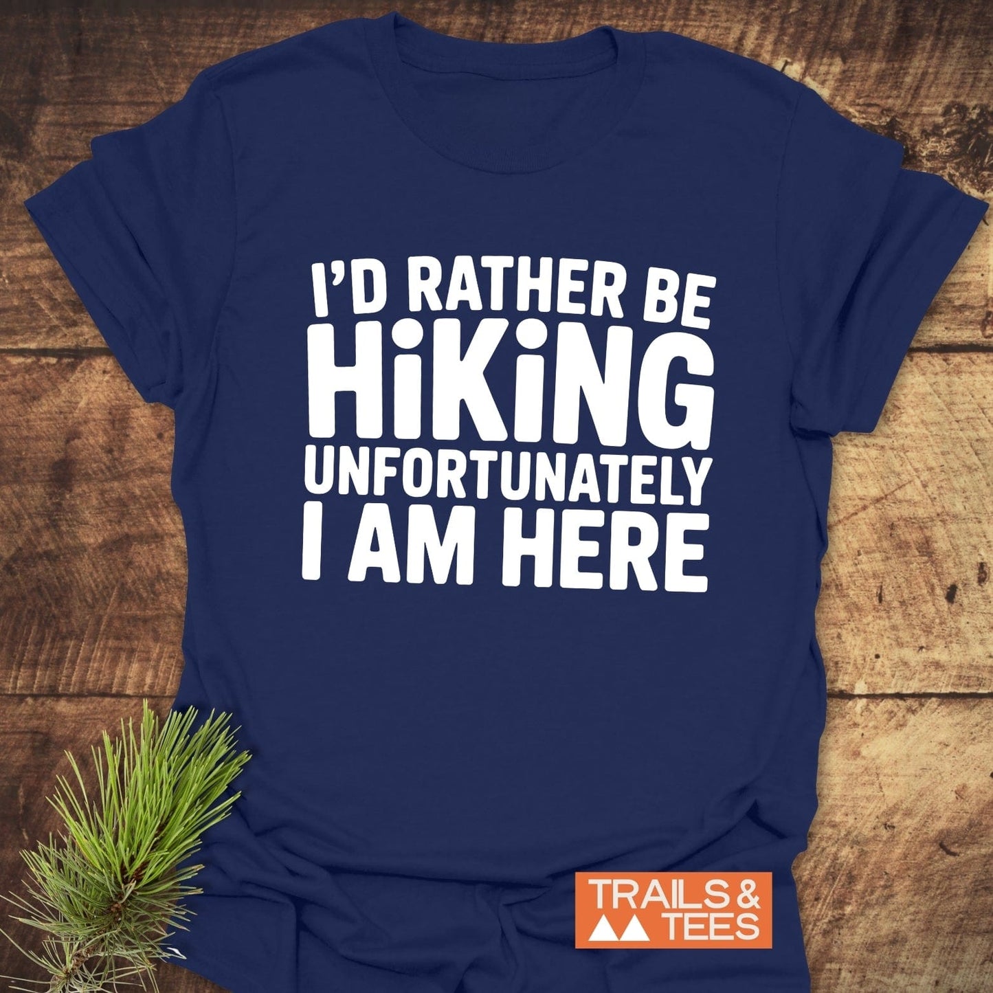I'd Rather Be Hiking... T-Shirt, navy with white text, orange Trails & Tees logo, on rustic surface, crafted from soft ring-spun cotton for comfort.
