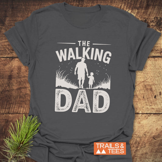 The Walking Dad T-Shirt features a graphic of a man and child, crafted from soft cotton for comfort, perfect for outdoor enthusiasts.