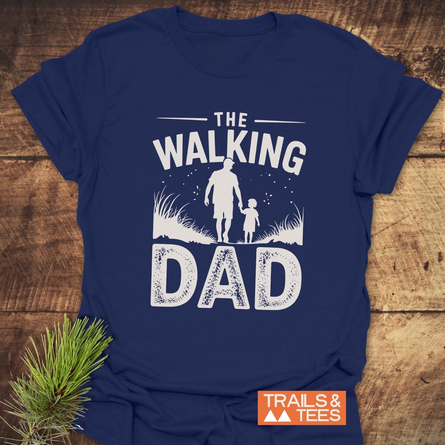 The Walking Dad T-Shirt features a father-child graphic, embodying outdoor adventures. Made from soft cotton, it offers comfort for everyday exploration.