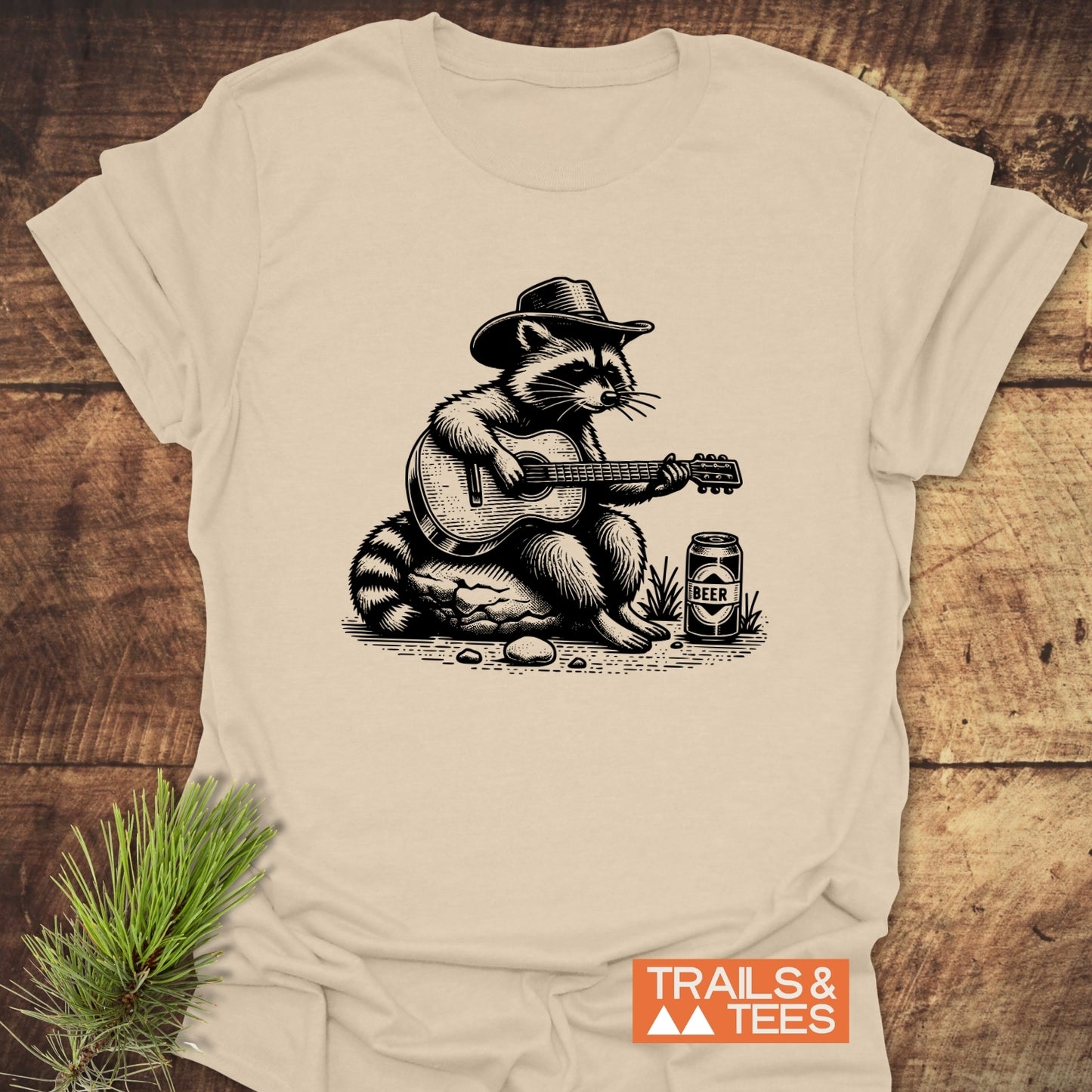 Guitar Playing Raccoon T-Shirt featuring a raccoon in a cowboy hat playing guitar, crafted from soft cotton for comfort and durability.
