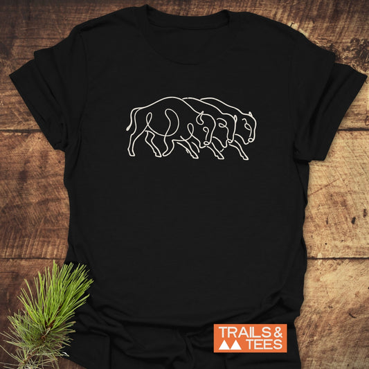 Minimalist Bison T-Shirt featuring three bison in a continuous-line design on black fabric, highlighted by the Trails & Tees logo, symbolizing outdoor adventure and comfort.