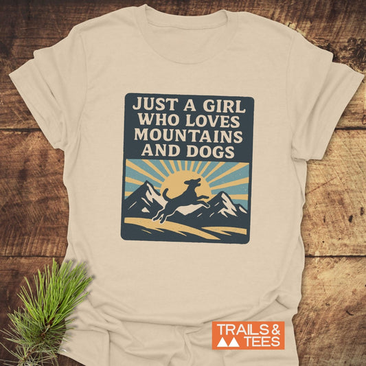Just A Girl Who Loves Dogs T-Shirt with a retro graphic of mountains, a dog silhouette, and sunrise, showcasing outdoor spirit and comfort.