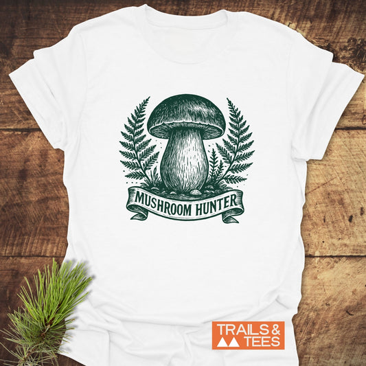 Mushroom Hunter T-Shirt featuring a dark green mushroom and fern illustration, crafted from soft ring-spun cotton, perfect for outdoor enthusiasts.