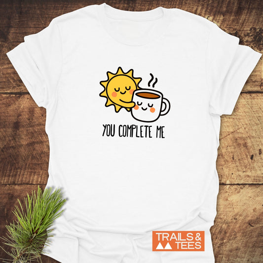 You Complete Me - Sun & Coffee T-Shirt featuring a cartoon sun hugging a coffee mug, printed on soft, durable cotton, perfect for outdoor adventures.