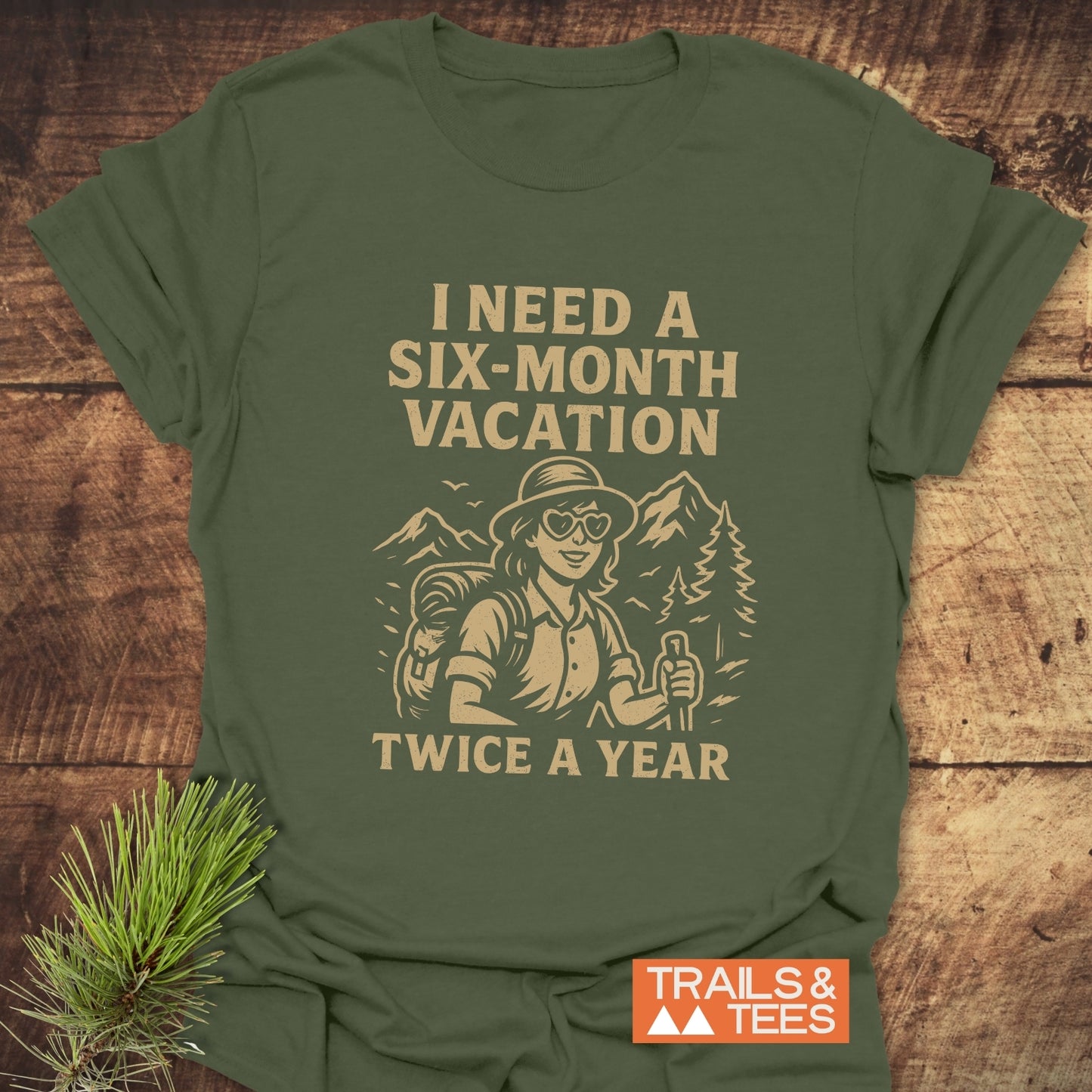Six-Month Vacation T-Shirt: Forest-green tee featuring a light tan graphic of a hiker with slogan, crafted from soft cotton for everyday adventure and comfort.