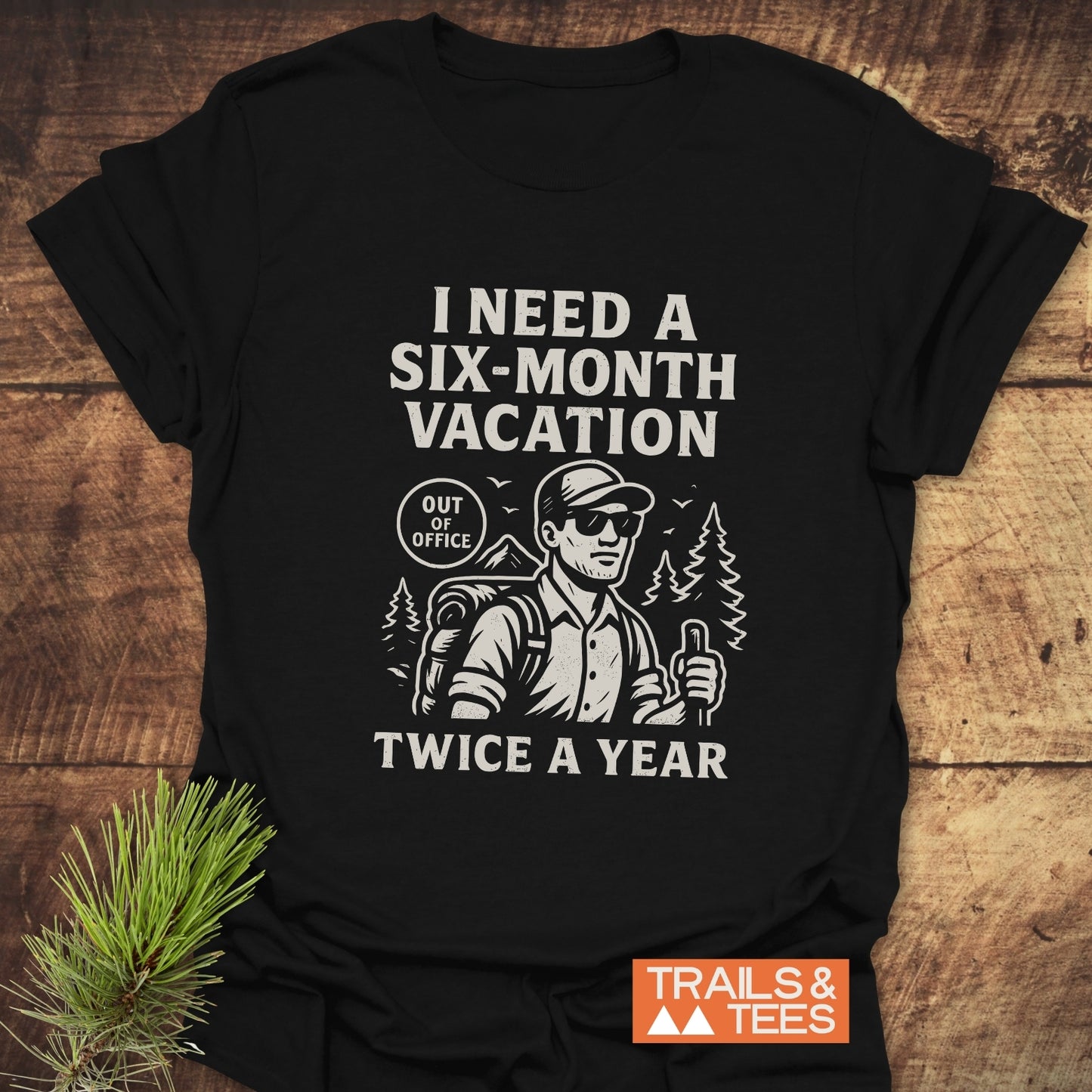 Six-Month Vacation T-Shirt featuring a bearded hiker graphic, slogan, and Out of Office badge; crafted from soft ring-spun cotton for lasting comfort.