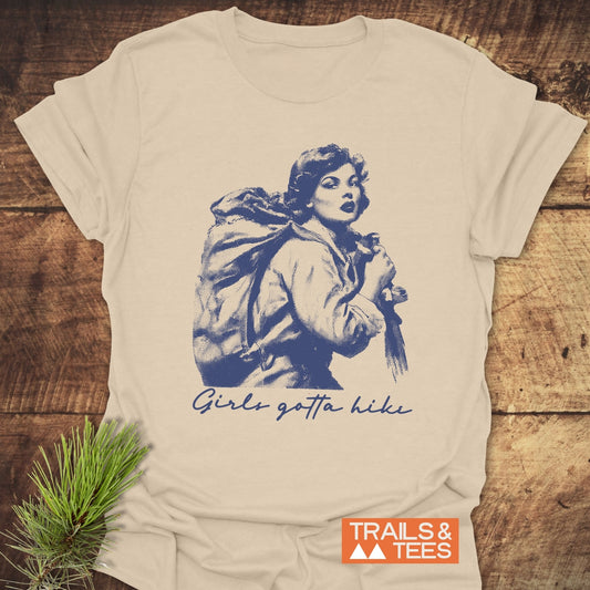 Girls Gotta Hike T-Shirt featuring a vintage-style illustration of a backpacker. Crafted from soft cotton, perfect for outdoor adventures and everyday wear.