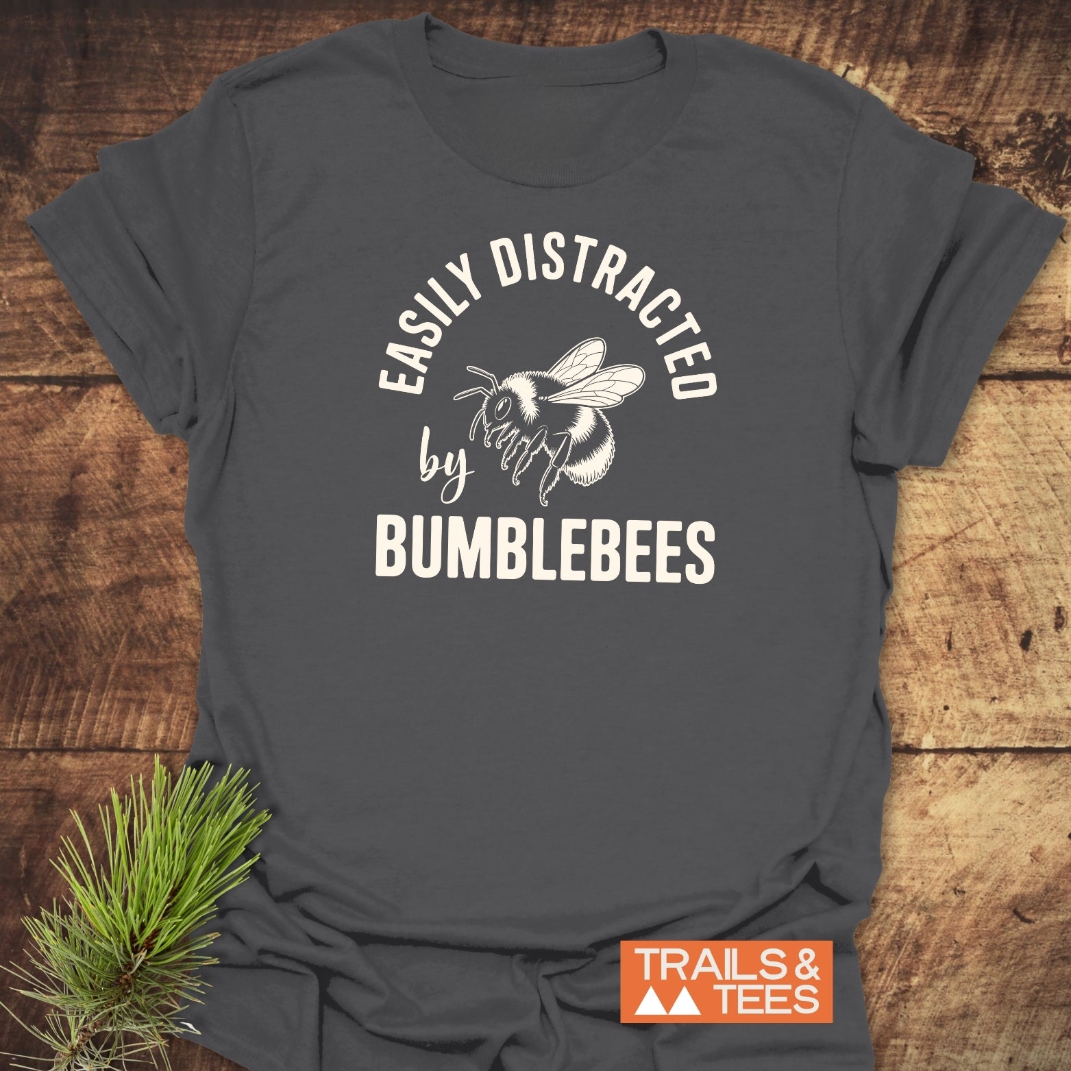 Heather-gray T-shirt featuring a bumblebee design with “Easily Distracted by Bumblebees,” emphasizing comfort and outdoor style, crafted from soft, lightweight ring-spun cotton.
