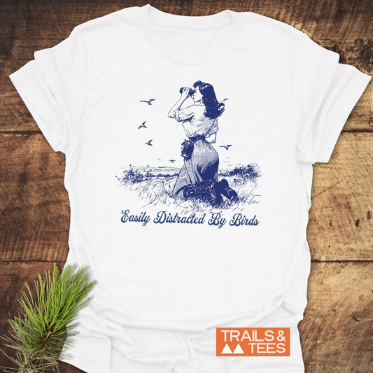 Easily Distracted By Birds T-Shirt with a vintage-style drawing of a woman observing birds, crafted from soft ring-spun cotton, ideal for outdoor enthusiasts.