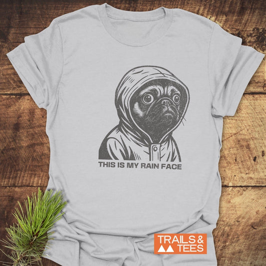 This Is My Rain Face T-Shirt featuring a cartoon pug in a raincoat. Made from soft ring-spun cotton, perfect for outdoor enthusiasts.