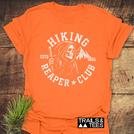 Hiking Reaper Club T-Shirt featuring a Grim Reaper graphic with mountain peaks, crafted from soft ring-spun cotton for outdoor enthusiasts, offering comfort and durability.