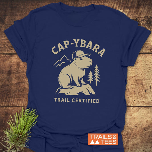 Cap-ybara T-Shirt featuring a capybara graphic with pine trees and mountain, highlighting trail-certified comfort and durability, perfect for outdoor adventures.