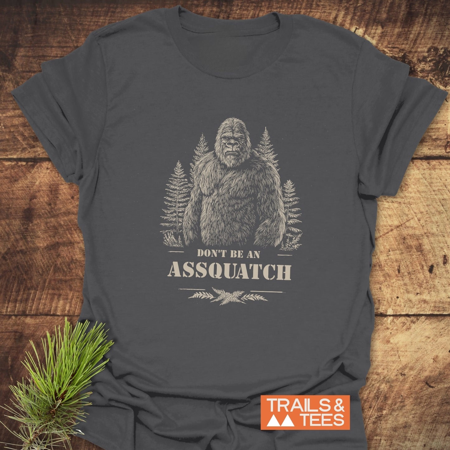 Assquatch T-Shirt featuring a sasquatch sketch and slogan, crafted from soft ring-spun cotton for comfort and durability, perfect for outdoor enthusiasts.
