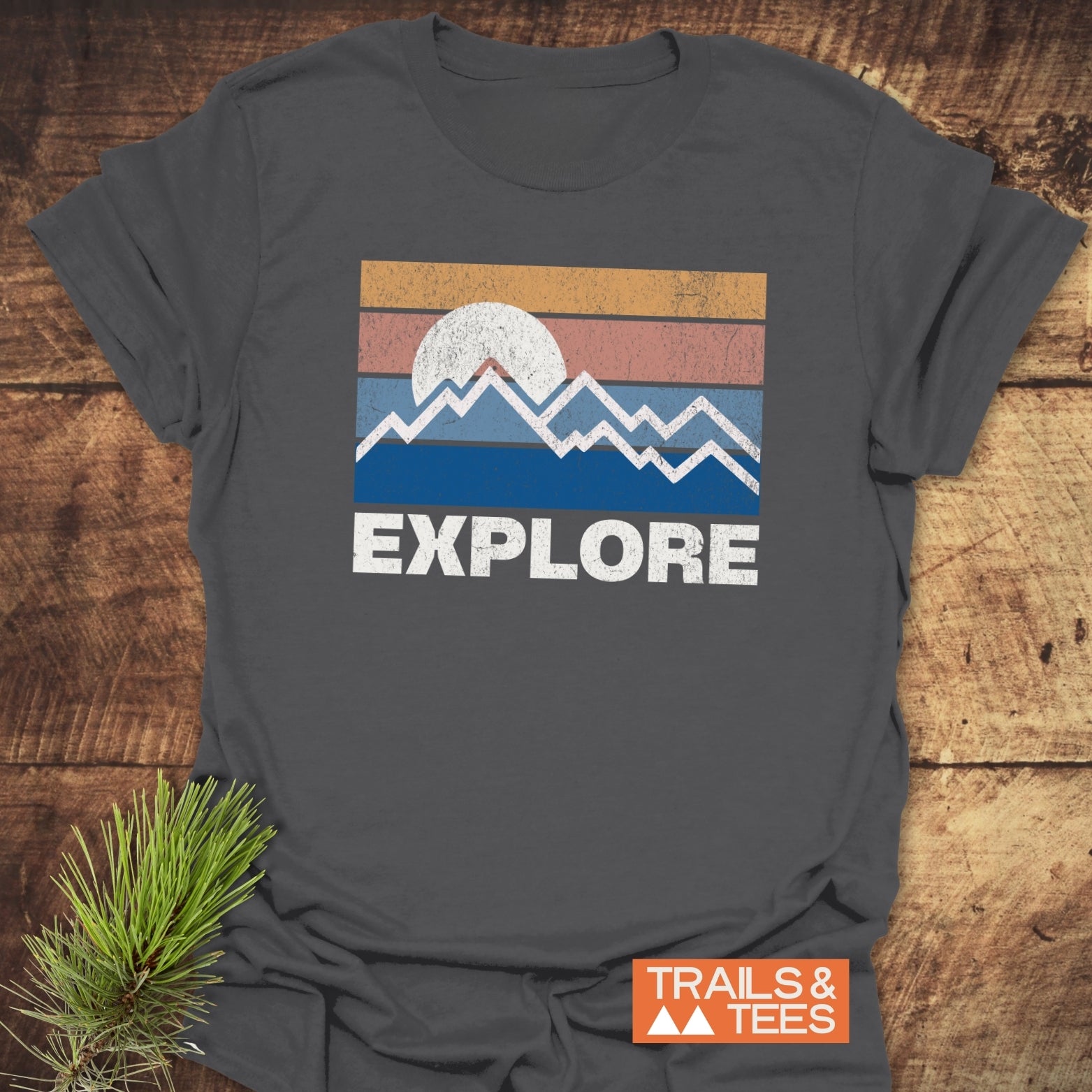 Explore Retro Sunset T-Shirt featuring a vintage sun and mountain design with EXPLORE text, crafted from soft cotton for outdoor enthusiasts.