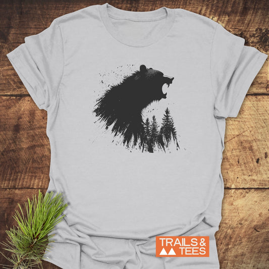 Roaring Bear Forest T-Shirt on wooden surface, featuring a bear profile with pine trees graphic, TRAILS & TEES logo, emphasizing outdoor comfort and durability.